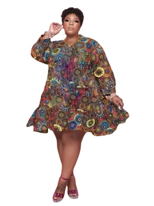 Detail of plus size V-neck dress featuring vibrant geometric circle prints and ruffled hem
