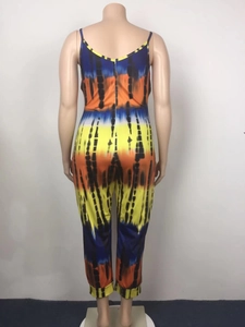 Detail view of the tie-dye printed jumpsuit back featuring thin straps and back zipper closure