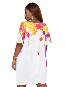 Detail of white loose-fit t-shirt dress featuring colorful artistic splash print design