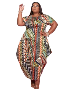 Detail of colorful geometric print and asymmetrical hem on this plus size short sleeve dress