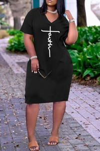 Detail of loose black V-neck dress with Faith cross print and practical side pockets