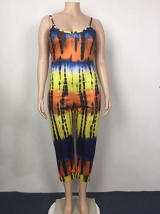 Detail of loose tie-dye jumpsuit featuring adjustable straps and vibrant colorful stripes