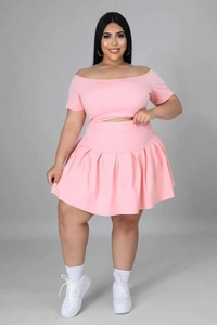 Detail view of pink short sleeve crop top and high-waisted pleated skirt two-piece set