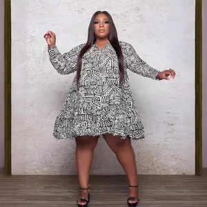 Plus size V-neck long sleeve dress with black and white geometric print and ruffled hem