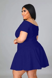Detail view of a two-piece set featuring off-shoulder top and pleated skirt in navy blue