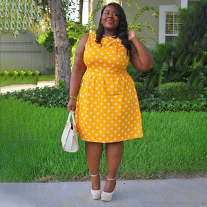 Vintage orange polka dot sleeveless plus size dress with a stylish bow neckline