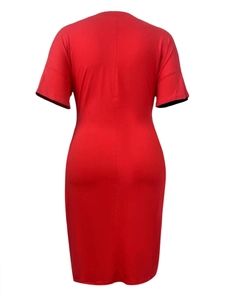Detail view of the back seam on a vibrant red short-sleeved bodycon dress with smooth fabric