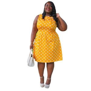 Detail of yellow plus size polka dot dress featuring a bow neckline and sleeveless design