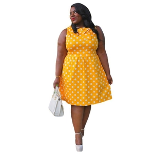 Detail view of yellow polka dot dress with sleeveless design and bow tie neckline
