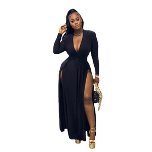 Detail of elegant black deep V-neck dress featuring long sleeves and high side slits