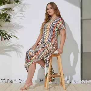 Plus size short sleeve dress with geometric print and irregular hem on a model