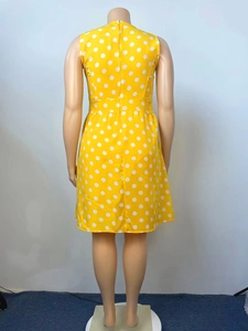Detail of yellow sleeveless polka dot dress with back zipper on a dress form