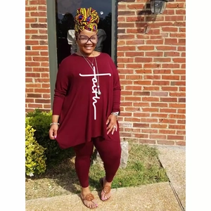 Women's burgundy long sleeve tunic and leggings set with faith print on red brick background