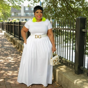 Detail of a white plus size maxi dress with short sleeves and gold logo buckled belt