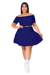 Detail of navy blue two-piece set featuring off-shoulder top and high-waisted pleated skirt
