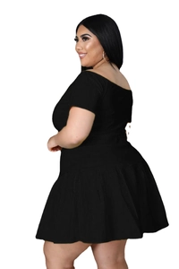 Detailed side view of plus size black two-piece set with off-shoulder top and pleated skirt