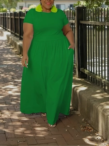 Detail of plus size bright green maxi dress with short sleeves and pleated waistline