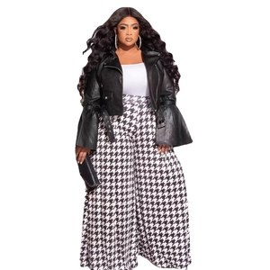 Detail of plus size high-waisted houndstooth wide leg trousers with a leather biker jacket