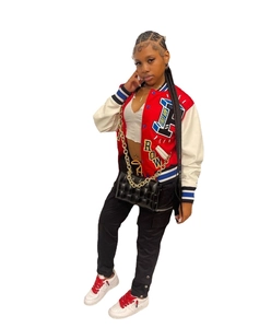Detail of a color-block varsity jacket featuring FIRST ROW embroidery and letter patches