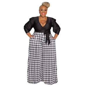 Detail of high-waist houndstooth wide-leg trousers and black V-neck waist-tie top set