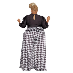 Detail view of the back cutout on black top with houndstooth wide leg pants for women