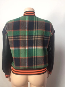 Back detail of plaid varsity jacket featuring green tartan fabric and black leather sleeves