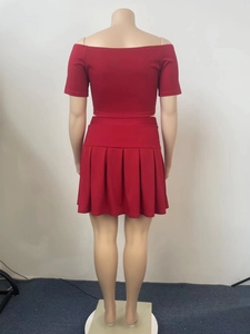 Rear view of red two-piece set featuring off-shoulder top and pleated mini skirt on mannequin