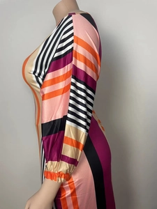 Close-up of geometric striped long sleeves with elastic cuffs on a colorful dress