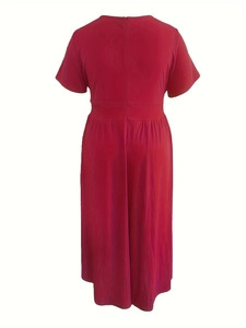 Back view of a deep red short sleeve dress featuring a high waist and wide hemline
