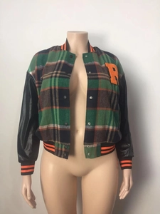 Detail of checkered baseball jacket with faux leather sleeves and orange letter R patch