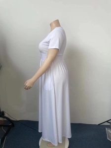 Detail view of high waist white short sleeve maxi dress showing the pleated skirt tailoring