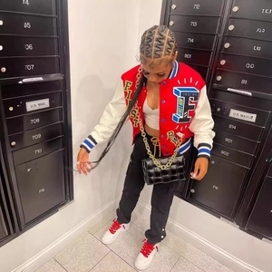 Women's red and white color block baseball jacket with letter patches and black woven bag