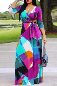 Detailed view of the deep V-neckline and colorful geometric print on the maxi dress