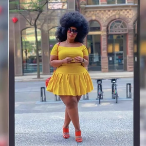 Sexy bright yellow two-piece set featuring off-shoulder crop top and pleated mini skirt