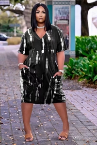 Detail of V-neck tie-dye printed dress with functional side pockets in casual style