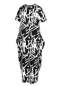 Detail of short sleeve maxi dress featuring black and white abstract print and side pockets
