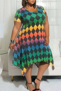 Detail of plus size dress featuring colorful harlequin print and asymmetric handkerchief hem