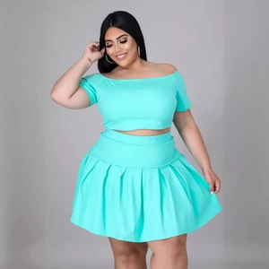 Sexy turquoise two-piece set for plus size women featuring crop top and pleated mini skirt