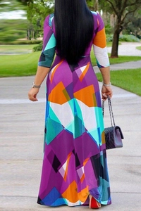 Back view of a slim-fit maxi dress featuring vibrant geometric color block patterns
