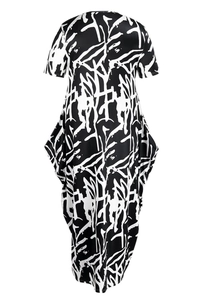 Close-up of short-sleeve midi dress with monochrome graffiti print and unique side drape
