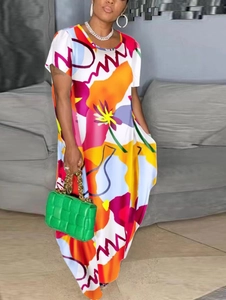 Close-up of short-sleeved long dress with bold abstract floral and wave patterns