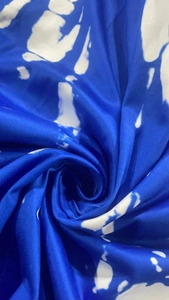Detail of the royal blue and white tie-dye print fabric with a silky satin texture