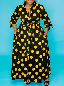 Maxi shirt dress with long sleeves featuring large yellow polka dots on black fabric