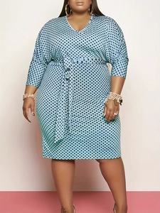 Detail of plus size V-neck polka dot dress in light blue with self-tie waist belt
