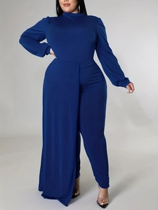Detail of royal blue high neck jumpsuit with elegant side drape and fitted waist