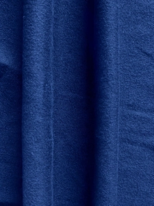 Detailed close-up of dark blue knit fabric showing fine vertical ribbed texture