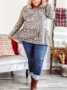 Detail of leopard print blouse featuring flared sleeves and a peplum hem design