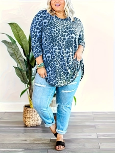 Close-up of women's plus size long sleeve top with blue leopard print and curved hemline