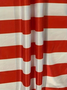 Detailed macro view of red and white striped fabric texture with elegant soft drapes