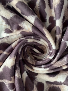 Macro shot of leopard print pleated fabric showing detailed vertical ribbed texture